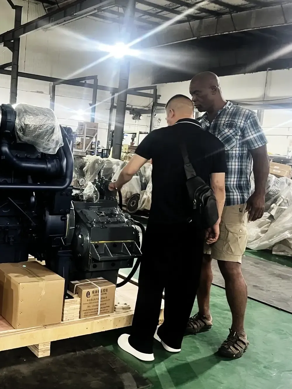 Client inspecting an engine and control system before shipment